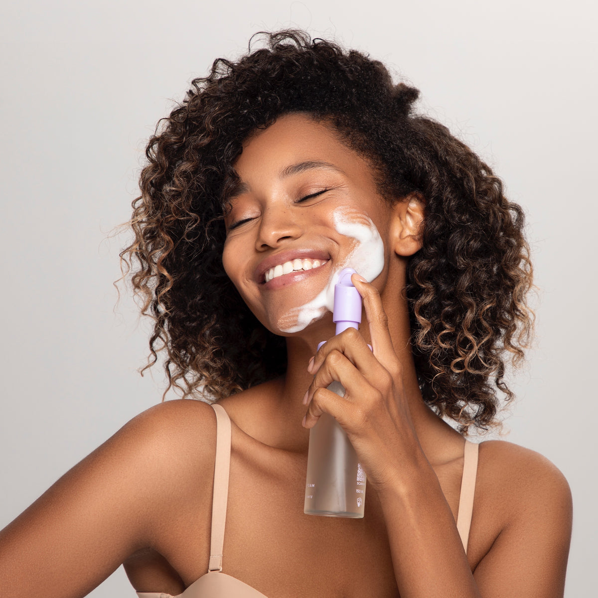 Woman cleansing her face with MUSE cleansing foam