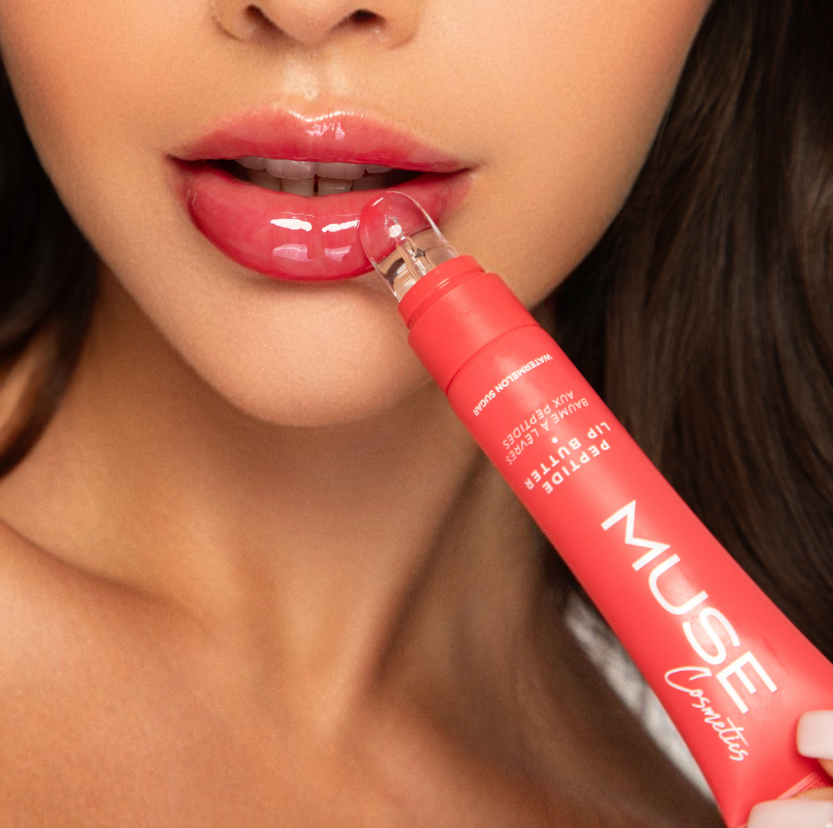 Applying MUSE Watermelon lip gloss