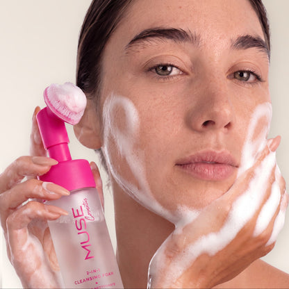 Woman cleansing her face with MUSE Travel cleansing foam